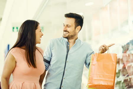 Happy couple in shopping mall.の写真素材