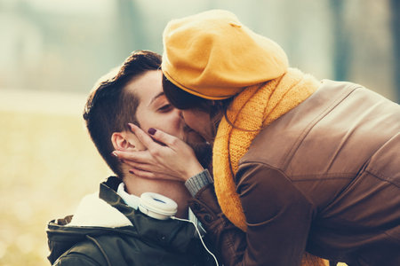 Young and attractive couple enjoying fall in the park.