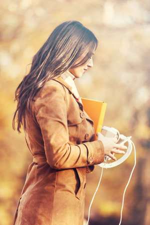 Young woman in the park using cellphone.の写真素材