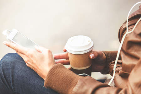 Young woman using cellphone in the park. の写真素材