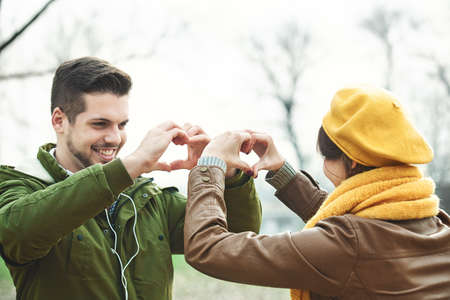 Young and attractive couple enjoying fall in the park.の写真素材