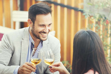 Happy couple drinking wine in a restaurant. Love concept. の写真素材