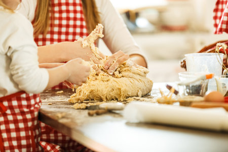 Little girl making dough with her mother. Family Concept. Food Concept.の写真素材