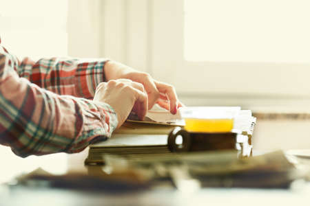 Woman looking her photo album. Memories. Close up concept. の写真素材