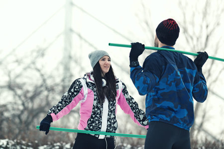 Sport couple exercising outdoors. Cold winter day.