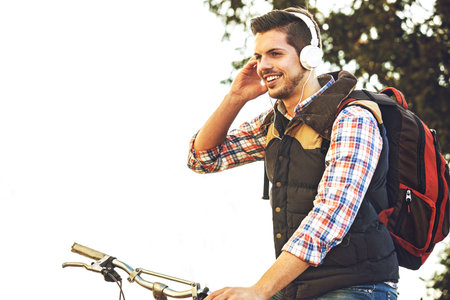 Young handsome man is making break while riding bike.