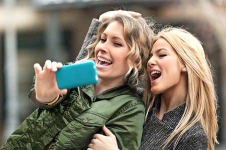 Young girls having fun in the city.の写真素材