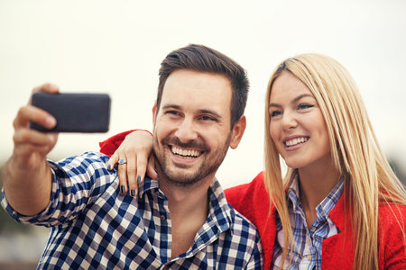 Young happy couple is enjoying outside.