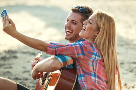 Happy couple having fun on the beach. Fun, summer, love concept.の写真素材