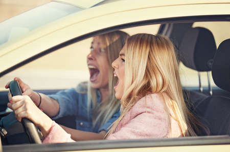 Beautiful girls in the car having accident.の写真素材