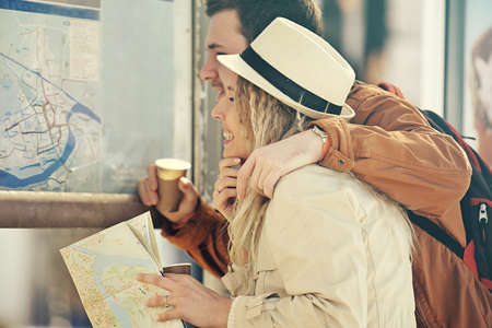 Couple tourist waiting for the bus and looking at city map.の写真素材