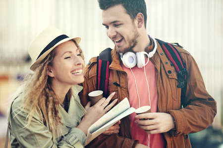 Couple tourist walking in downtown and looking at city map.の写真素材