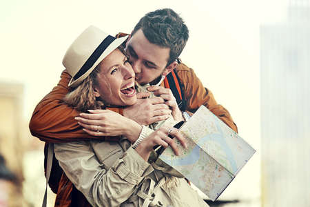 Couple tourist walking in downtown and looking at city map.の写真素材