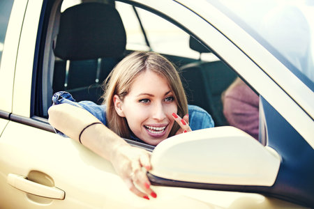 Beautiful girls in the car. They are happy to travel.