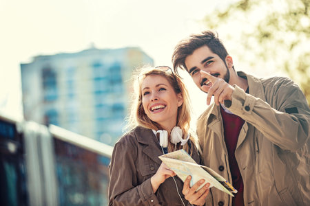 Young tourists in the city looking for taxi.