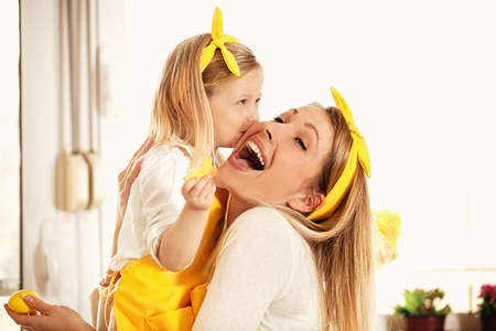 Mother and daughter is enjoying coloring Easter eggs.の写真素材