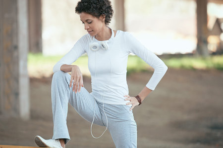Beautiful young woman exercising outdoors. Morning workout. Living healthy lifestyle.