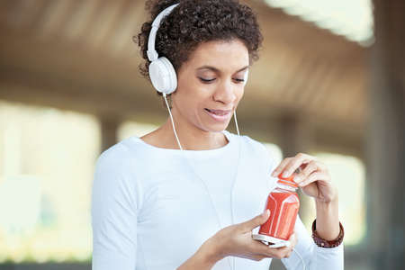 Beautiful young woman exercising outdoors. Morning workout. Living healthy lifestyle.の写真素材