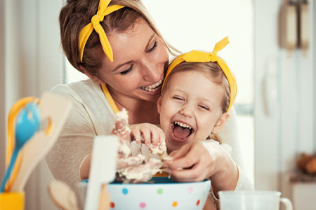 Mum and daughter baking cakes in the morning.