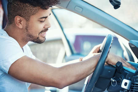 Young handsome man is cleaning his car.の写真素材
