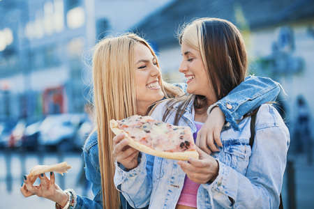 Happy young women having fun in the city.の写真素材