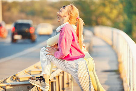Sportive young woman exercising outdoors. Lilving healthy lifestyle.の写真素材