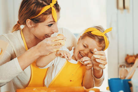 Mum and daughter baking cakes in the morning.の写真素材