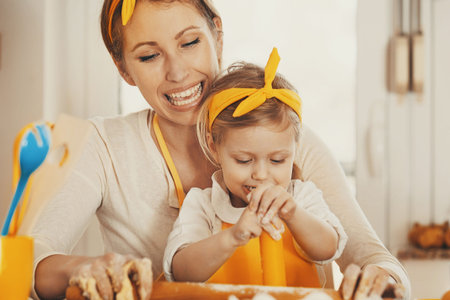 Mum and daughter baking cakes in the morning.