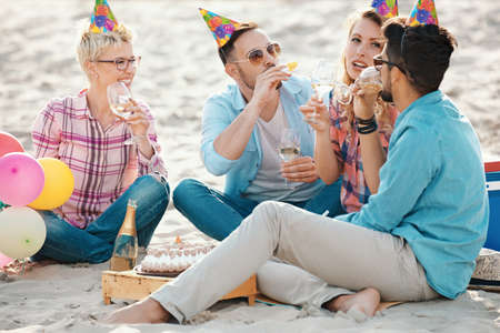 A group of people having birthday party on the baech.の写真素材