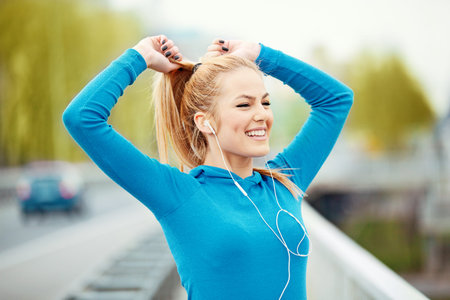Young blonde woman is jogging early in the morning.