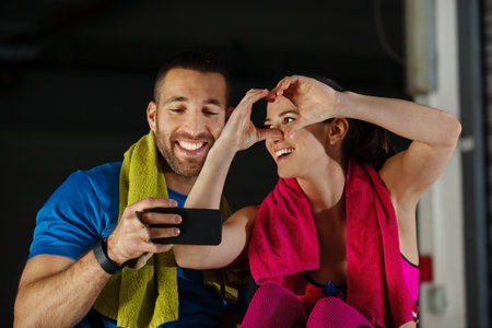 Young athlete couple relaxing after training in garage.
