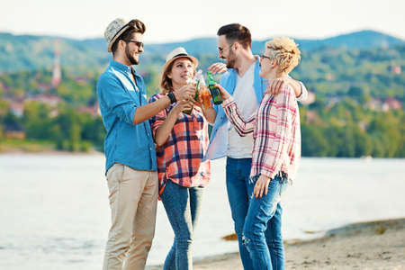 A group of friends having great time together on the beach.の写真素材