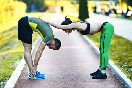 Early morning workout. Happy couple relaxing after working out. Living healthy lifestyle.の写真素材