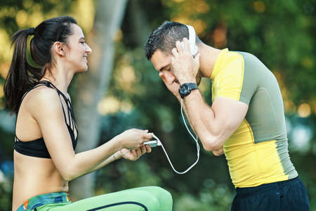 Early morning workout. Happy couple relaxing after working out. Living healthy lifestyle.の写真素材