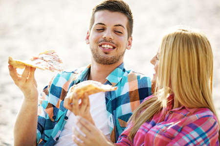 Young couple in love enjoying their free time on the beach.の写真素材