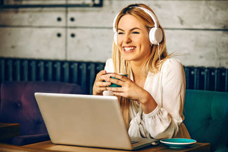 Modern business woman is drinking coffe and having break.の写真素材