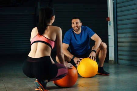 Young couple is training with wallball in garage.の写真素材