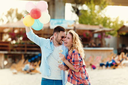 Happy couple in love having great time together on the beach.の写真素材