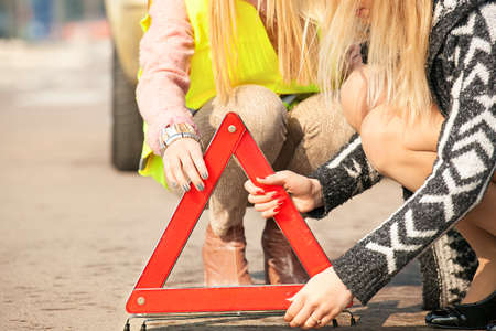 Beautiful young woman having trouble with car.の写真素材