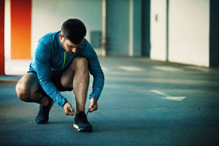 Young athlete man is preparing for exercise in garage.の写真素材