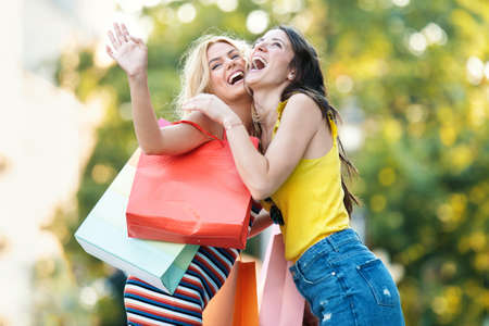 Young and attractive women are enjoying shopping.の写真素材