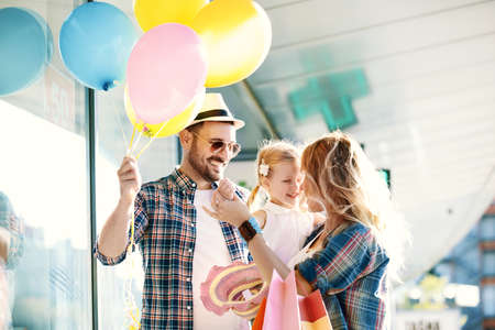 Happy family walking along the shopping mall.の写真素材