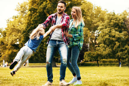 Happy family of three enjoying free time in the nature.の写真素材