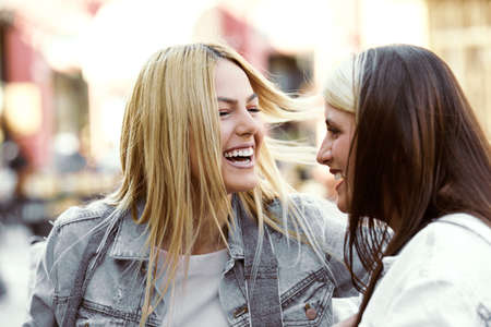 Happy young women having fun in coffee shop.の写真素材