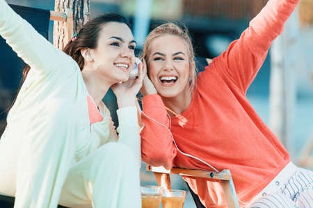 Sportive young woman drinking orange juice after exercising.の写真素材