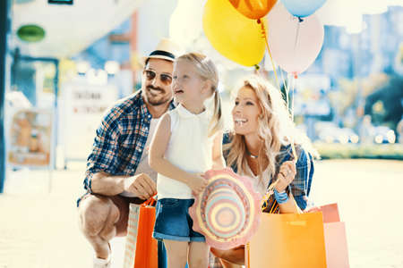 Happy family walking along the shopping mall.の写真素材