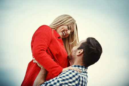 Young happy and attractive couple is enjoying outside.