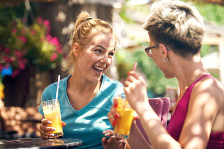 Two young women are drinking juice in the morning.の写真素材