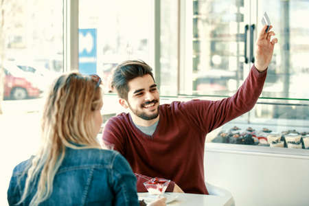 Couple enjoying pastry shop early in the morning.の写真素材