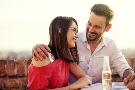 Young and attractive couple is enjoying sunset.
